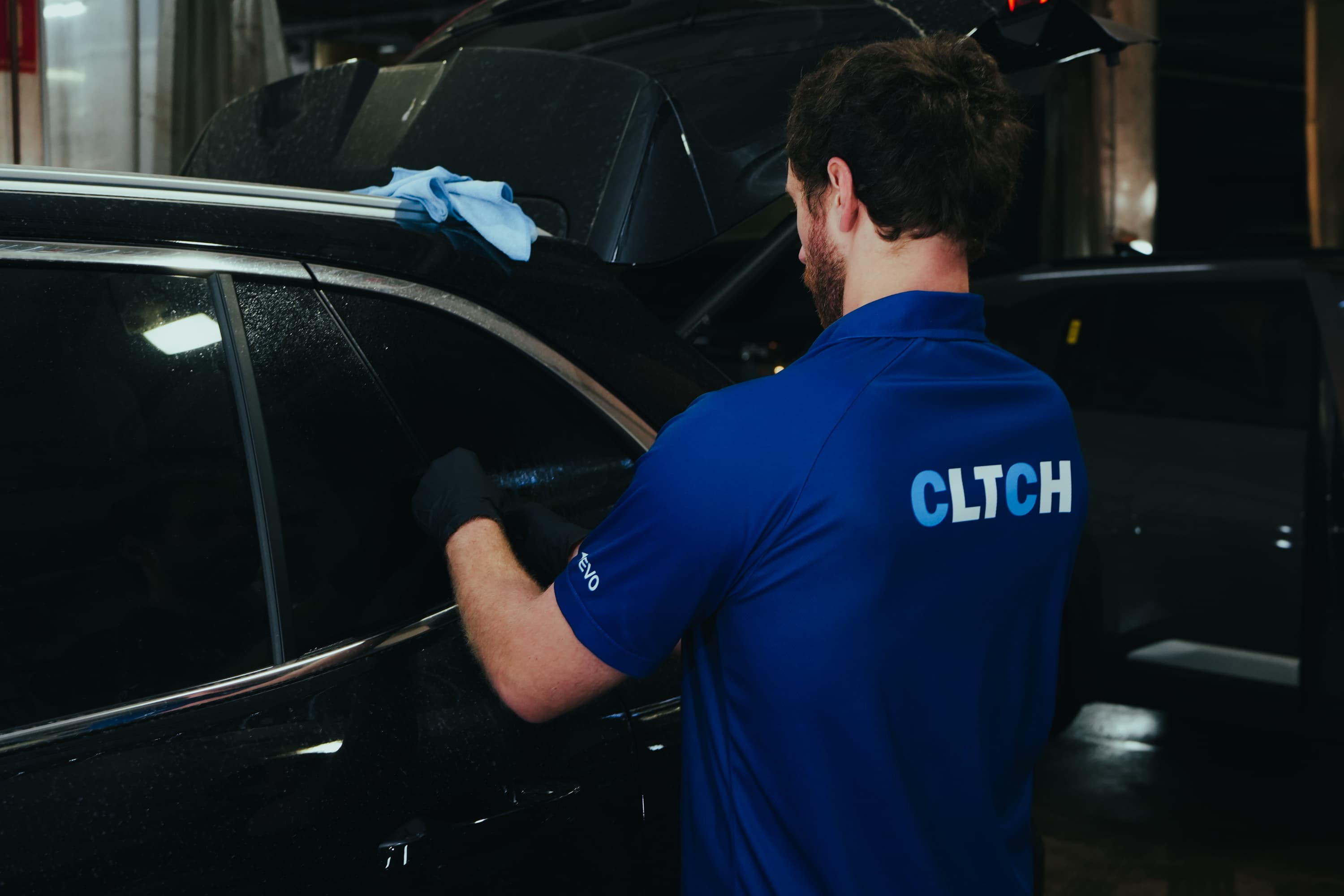 CLTCH technician prepping vehicles at volume before sale day